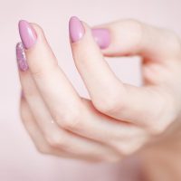 person-s-hand-with-pink-manicure-939835